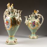A PAIR OF SEVRES STYLE EWERS, with figural mounts, painted with panels of flowers. 16ins high.