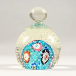 A MILLEFIORE STYLE GLASS PAPERWEIGHT, with moulded handle. 4.5ins high.