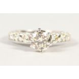 AN 18CT DIAMOND RING, THE CENTRAL STONE OF 1.25 cts flanked by six stepped diamonds to the