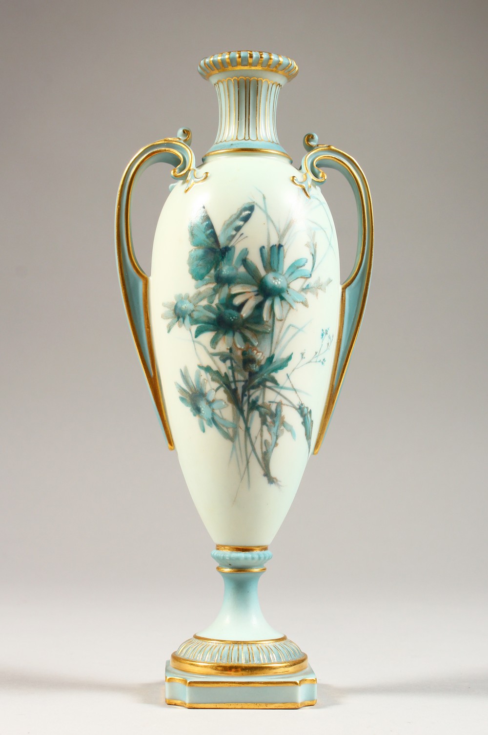 A ROYAL WORCESTER PEDESTAL VASE, No. 1957, pale blue ground decorated with floral sprays. 8.5ins