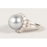 A SILVER, PEARL AND CUBIC ZIRCONIA RING.