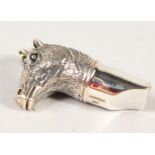 A NOVELTY SILVER HORSE WHISTLE.