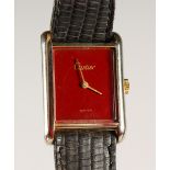 A CARTIER LADIES' WRISTWATCH, with red enamel dial.