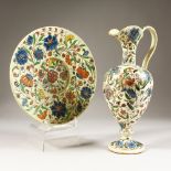 A CONTINENTAL TERRACOTTA EWER AND STAND, with polychrome floral decoration. 13ins high.