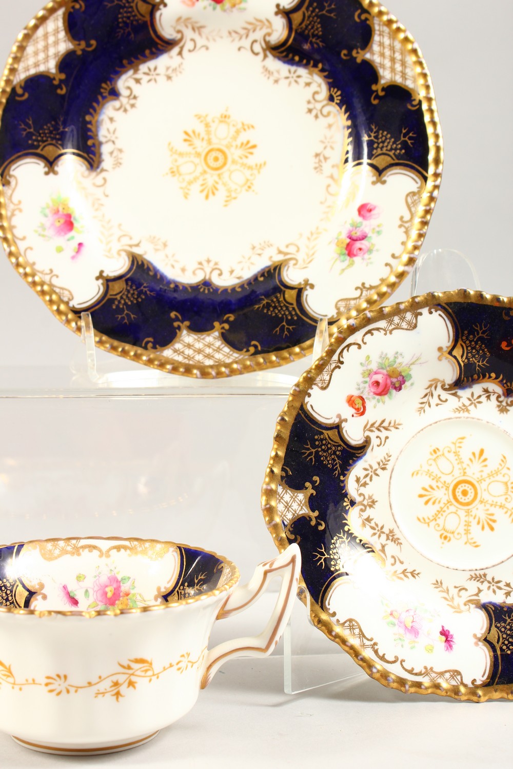 A COALPORT TRIO AND A HAMMERSLEY TRIO, blue and gilt painted with roses. - Image 5 of 7