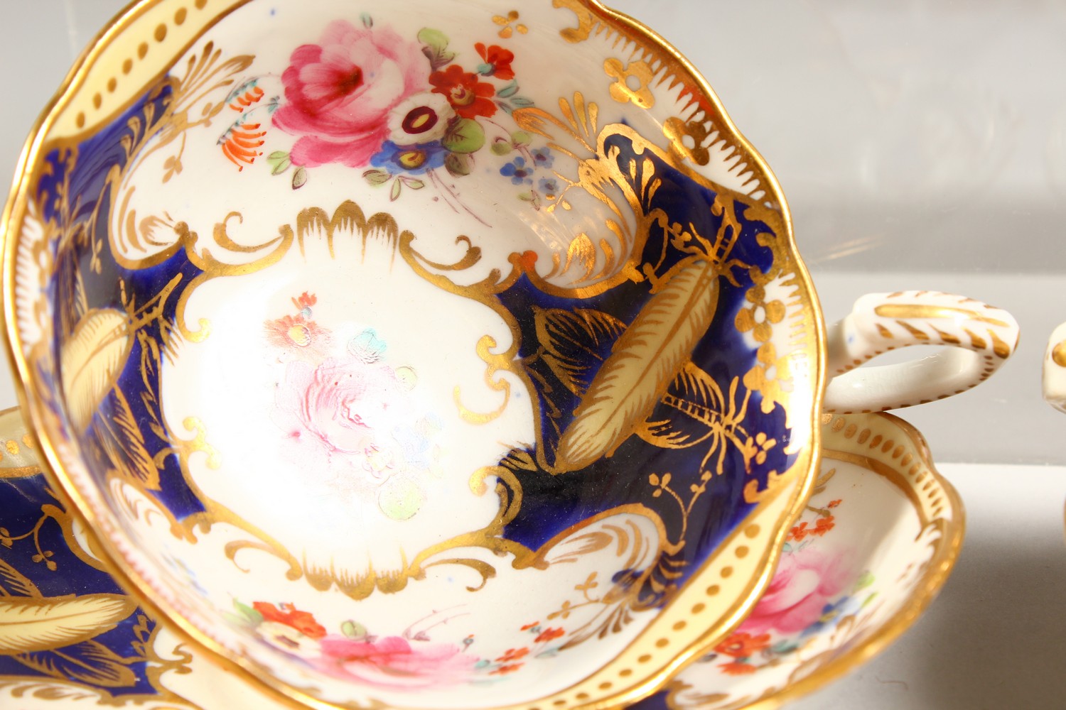 TWO COALPORT PORCELAIN TRIOS, blue and gilt decorated with roses. - Image 3 of 7