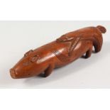 A POLYNESIAN CARVED WOOD PIG. 9ins long.