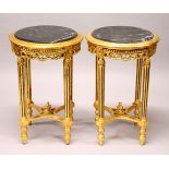 A PAIR OF FRENCH STYLE GILTWOOD CIRCULAR STANDS, inset with black marble tops. 1ft 7ins diameter x