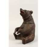 A BLACK FOREST STYLE CARVED BEAR TOBACCO JAR. 8ins high.