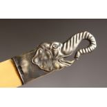 A LETTER OPENER, the silver handle modelled as an elephant head. 10ins long.