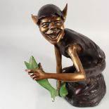 A AMUSING BRONZE MODEL OF A PIXIE, holding a fish in each hand. 19ins high.