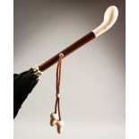 AN EARLY 20TH CENTURY LADIES' PARASOL, with ivory "golf putter" style handle and acorn shaped