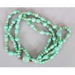 A LONG TURQUOISE TWO ROW NECKLACE.