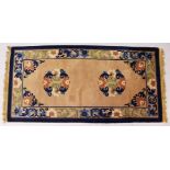 A CHINESE RUG, with beige ground and motifs in blue. 5ft x 2ft 3ins.