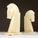 A PAIR OF ONYX HORSE HEAD BOOK ENDS. 11ins high.