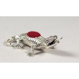 A NOVELTY SILVER CROCODILE PIN CUSHION.