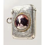 AN ENGRAVED SILVER VESTA CASE, with later enamel of a dog.