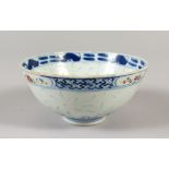 A 19TH CENTURY CHINESE BLUE & WHITE & ENAMEL DECORATED RICE PATTERN PORCELAIN BOWL, the interior