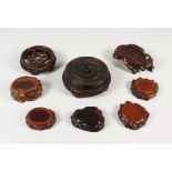 A COLLECTION OF EIGHT CHINESE / ORIENTAL HARDWOOD STANDS, including a small pair, a beautifully