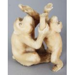 A JAPANESE MEIJI PERIOD IVORY OKIMONO OF TWO PLAYING MONKEYS, unsigned, the fur naturalistically