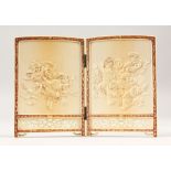 A FINELY CARVED JAPANESE TWO-FOLD IVORY MINIATURE TABLE SCREEN, one side depicting family