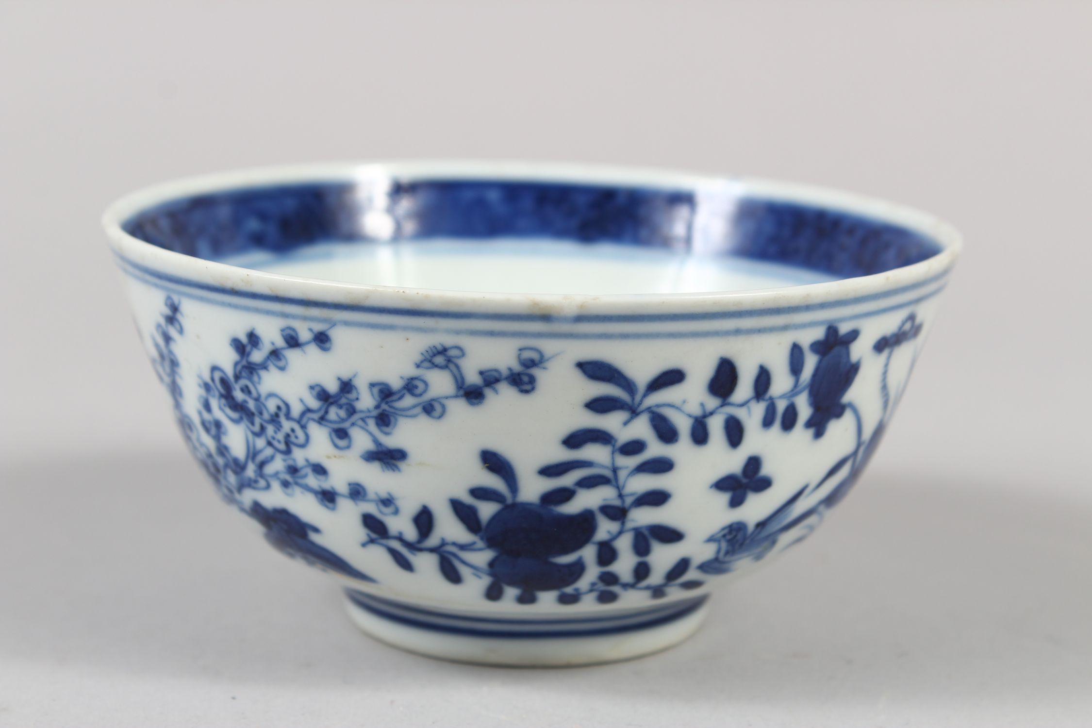 A CHINESE BLUE AND WHITE PORCELAIN BOWL, decorated with butterflies, birds amongst flora, 6cm - Image 3 of 7