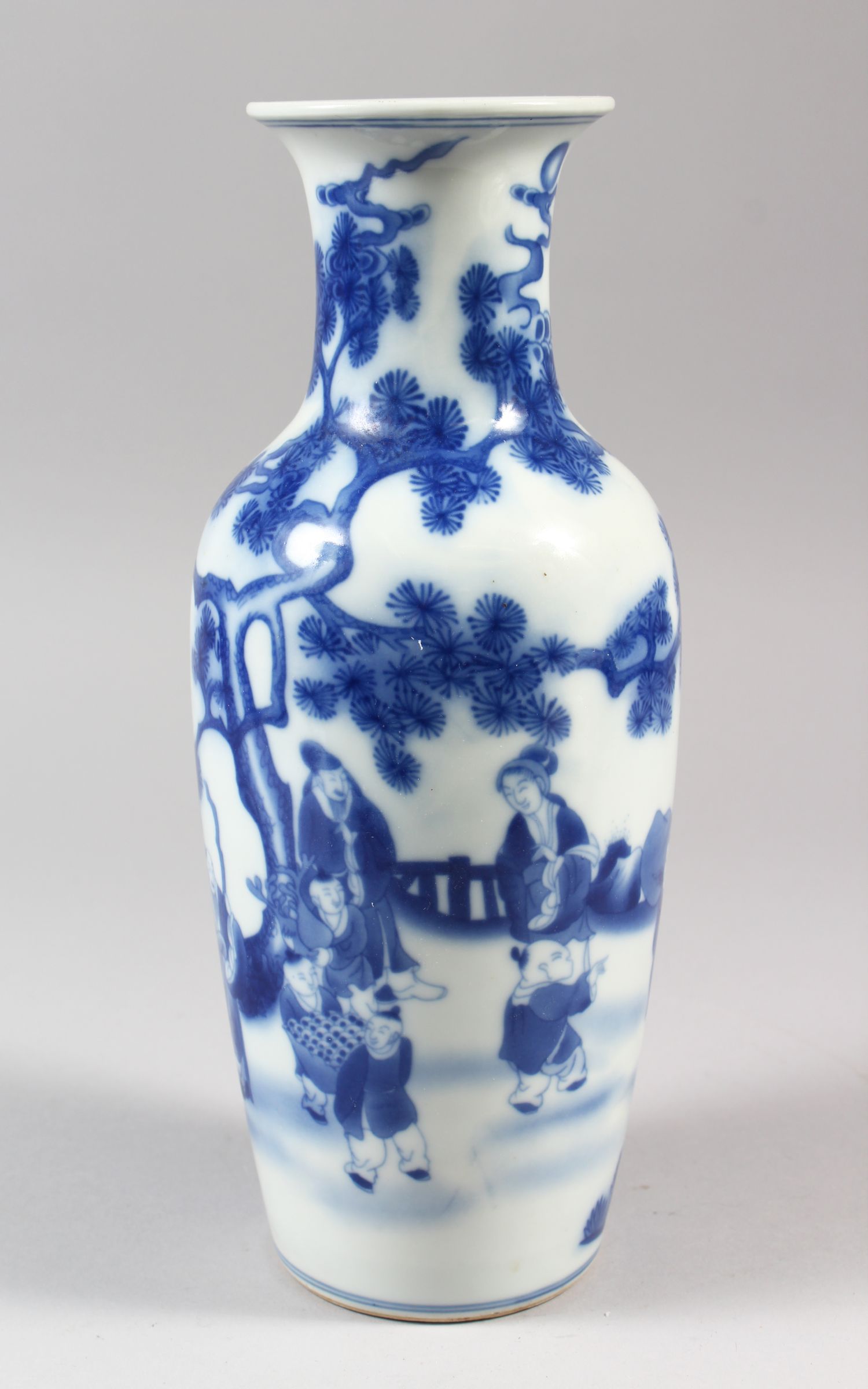 A SLENDER CHINESE BLUE AND WHITE PORCELAIN VASE, decorated with working locals surrounded by trees