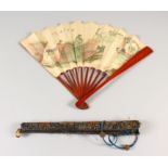 AN UNUSUAL EARLY 20TH CENTURY CHINESE PAPER FAN, with red lacquered wood sticks and guards, together