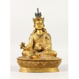 A SINO-TIBETAN GILT BRONZE FIGURE OF A KARMAPA, seated on a lotus plinth and bearing a vajra and a