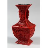 A GOOD CHINESE CINNABAR LACQUER VASE, carved with floral scenes, 20cm high, 10cm wide, 8cm deep.