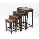A NEST OF FOUR 19TH/20TH CENTURY CHINESE RECTANGULAR HARDWOOD TABLES, each with a pierced and carved