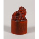 AN EARLY 20TH CENTURY CHINESE HORN SEAL, well carved with a Buddhistic lion and pup on an oval-