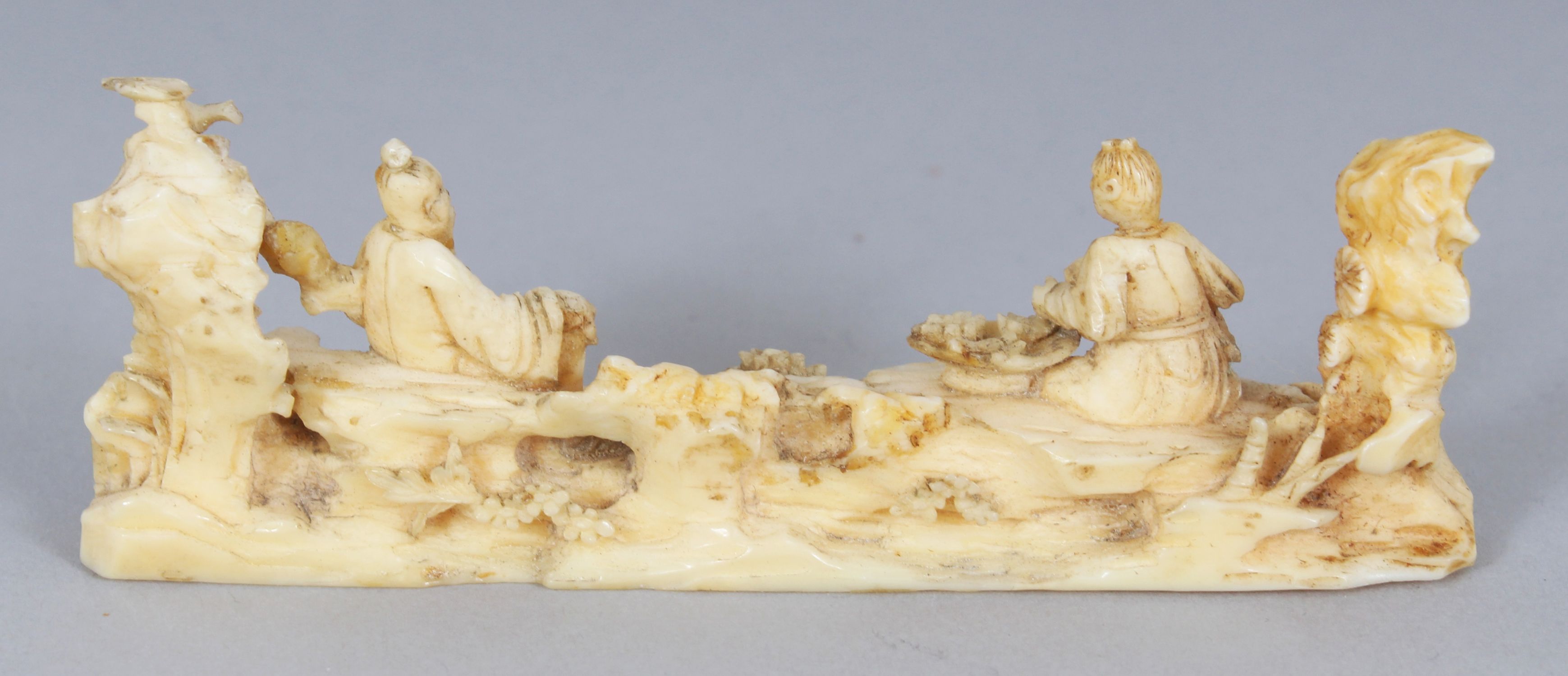 AN UNUSUAL 19TH CENTURY CHINESE IVORY BRUSH REST, carved in the form of a sage and his attendant, - Image 2 of 4