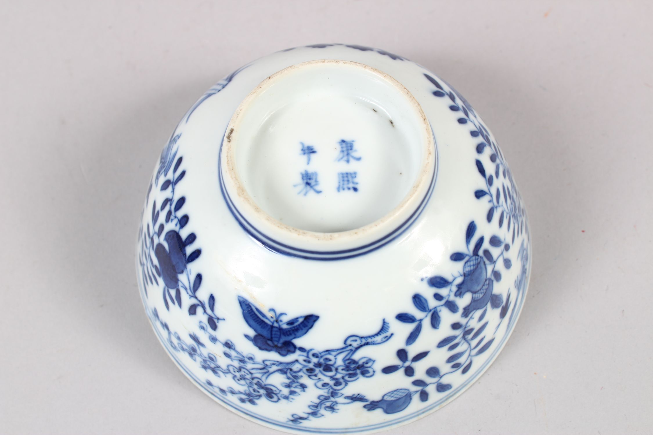 A CHINESE BLUE AND WHITE PORCELAIN BOWL, decorated with butterflies, birds amongst flora, 6cm - Image 6 of 7