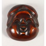 A JAPANESE LARGE CARVED BOXWOOD NETSUKE OF OKAME, Meiji period, artist signed to the rear,7cm