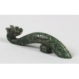 A CHINESE GREEN JADE BELT BUCKLE, in the form of a dragon, 11cm wide.
