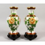 A PAIR OF CHINESE CLOISONNE ENAMEL VASES WITH STANDS, white ground depicting birds amidst floral