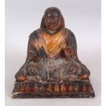 A JAPANESE MEIJI PERIOD LACQUERED WOOD MODEL OF A MONK, seated in meditation on a rectangular