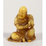 A CHINESE CARVED SOAPSTONE FIGURE OF LOHAN, modelled holding a foo dog by his shoulder, 6cm high,