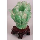 AN EARLY 20TH CENTURY CHINESE GREEN BOWENITE CARVING OF A LOTUS FLOWER, together with a fitted