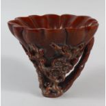 A CHINESE CARVED HORN LIBATION CUP, carved with pine trees, prunus and bamboo, bamboo carving