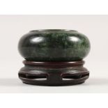 A SMALL CHINESE SPINACH GREEN JADE WATER POT, together with a fitted wood stand, the stone of