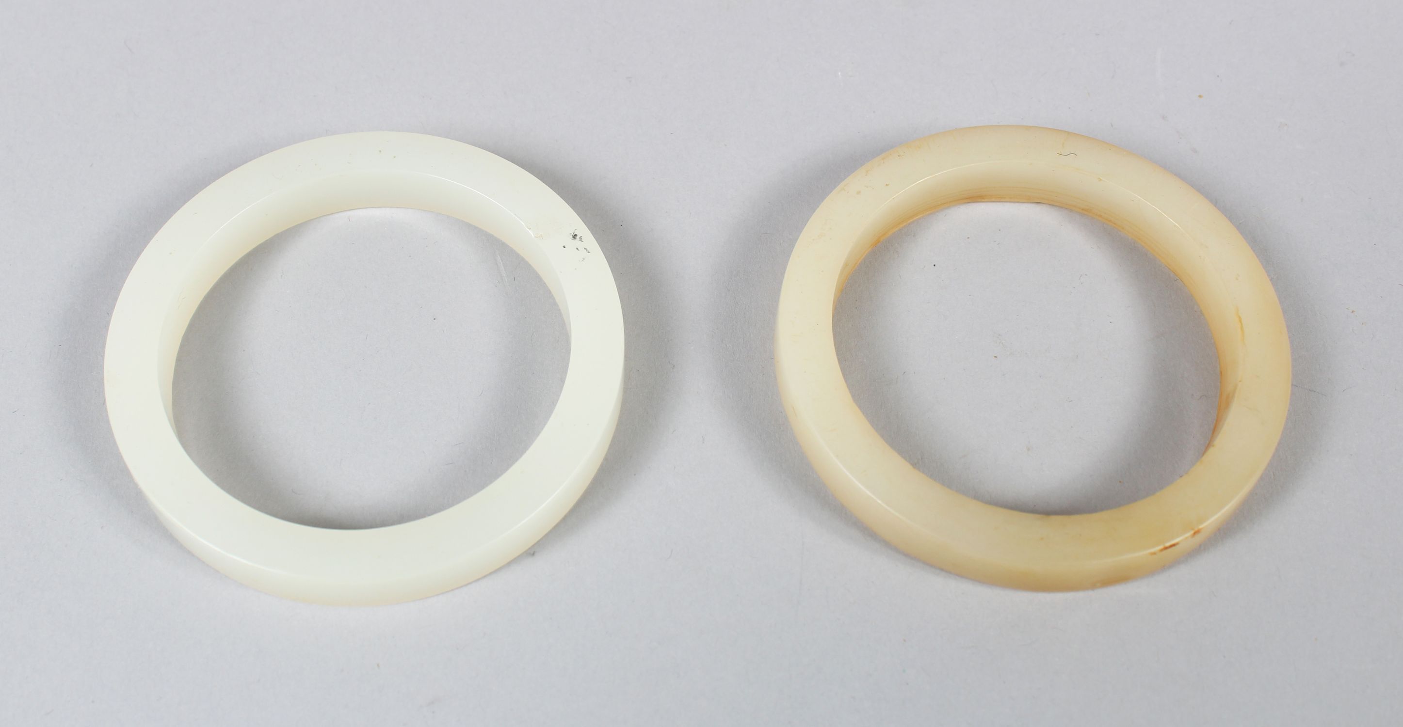 A CHINESE WHITE JADE BANGLE, also another similar jade bangle, 7.5cm diameter. - Image 2 of 2