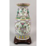 A LATE 19TH CENTURY CHINESE FAMILLE ROSE CANTON PORCELAIN VASE, fitted for electricity, painted with