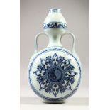 A CHINESE MING STYLE BLUE & WHITE PORCELAIN MOON FLASK, leaf shaped handles with decoration of