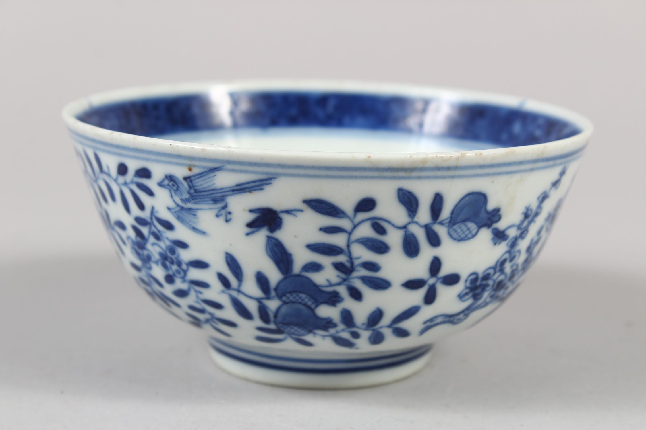 A CHINESE BLUE AND WHITE PORCELAIN BOWL, decorated with butterflies, birds amongst flora, 6cm - Image 4 of 7