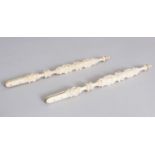 A PAIR OF ORIENTAL CARVED IVORY FAN HANDLES. 20.1cm long.