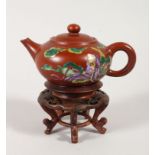 A GOOD CHINESE YINXIN TEAPOT WITH HARDWOOD STAND, decorated with scenes of a figure sat amongst