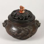 A GOOD HEAVY CHINESE BRONZE CENSOR WITH CARVED WOODEN LID, with lionhead handles and decorated in