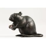 A JAPANESE MEIJI PERIOD BRONZE MODEL OF A RAT HOLDING A NUT, carved fur details, signed to its belly